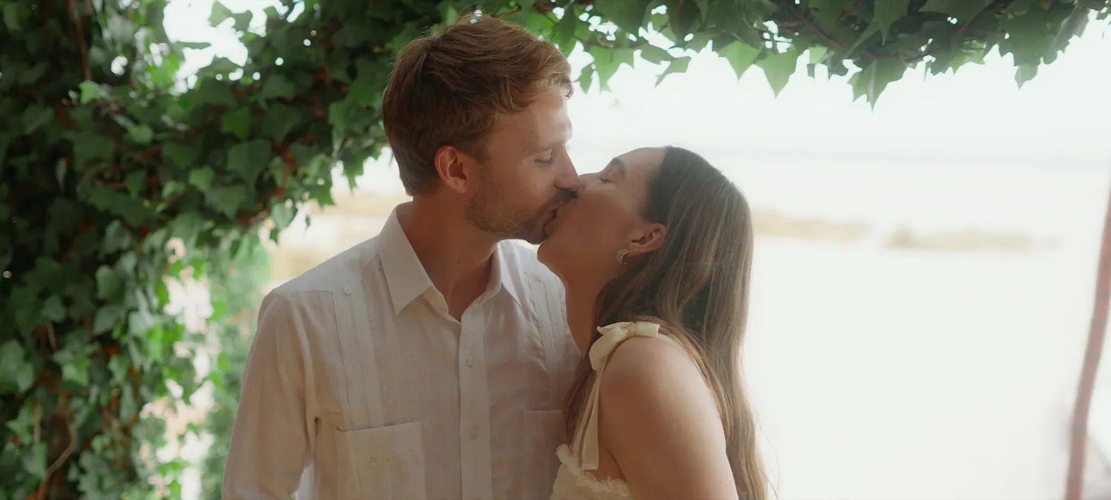 The couple kissing during their beach wedding ceremony in Dakhla