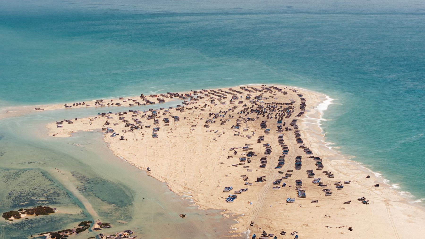 Aerial view of fishing boats on a sand spit near Dakhla