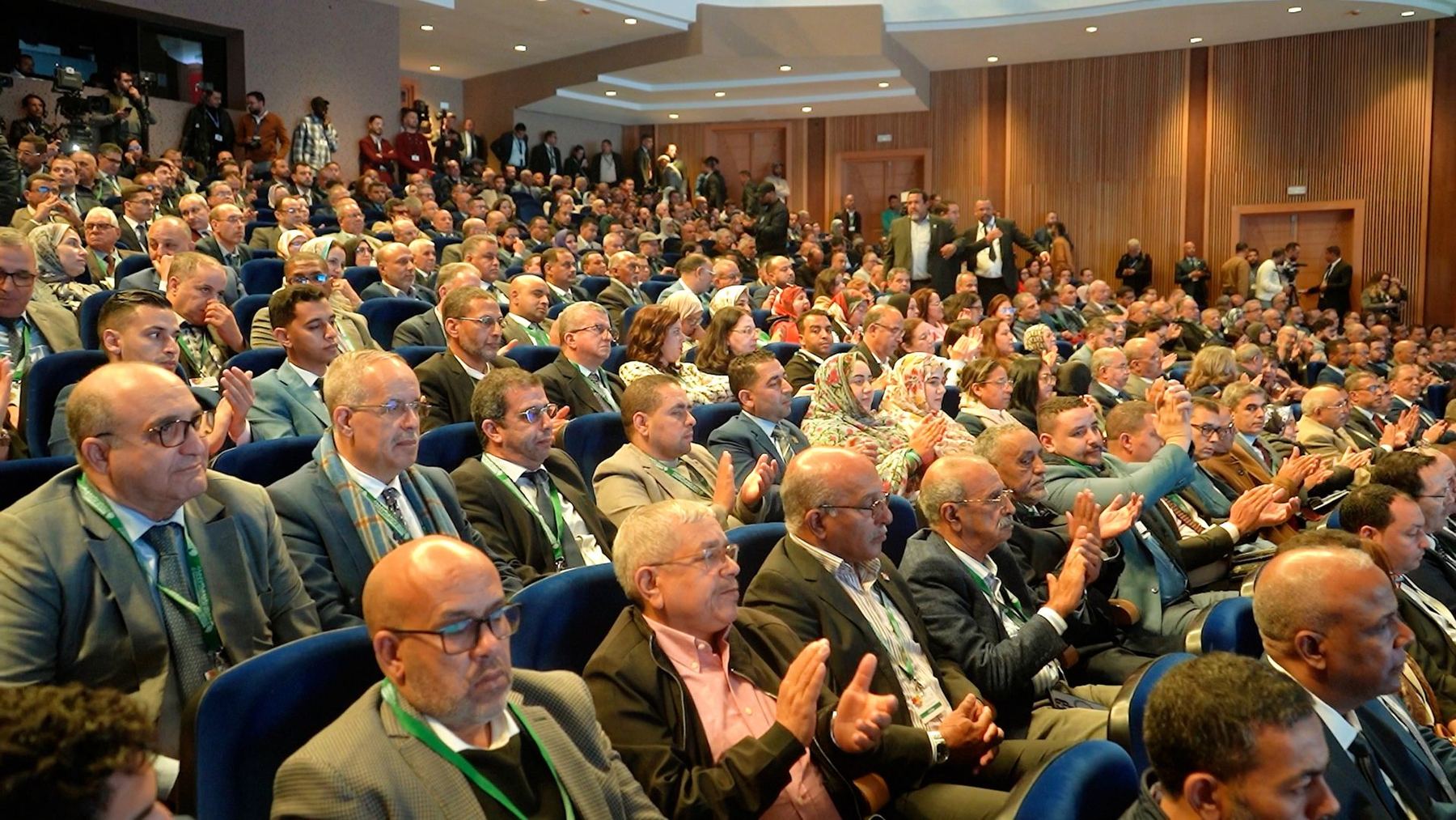 Delegates applauding in the auditorium